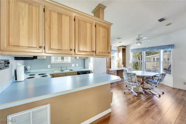 a kitchen with a sink stove top oven and cabinets