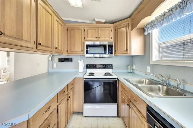 a kitchen with a sink stove and microwave