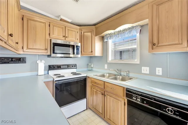 a kitchen with stainless steel appliances a table and chairs in it