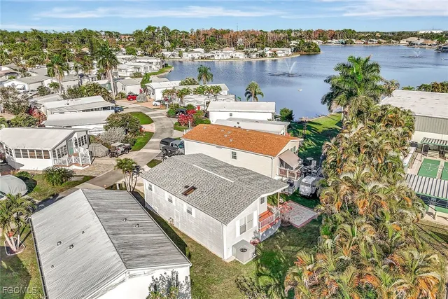 an aerial view of a house with swimming pool and lawn chairs