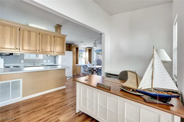 a kitchen with kitchen island granite countertop a sink and cabinets