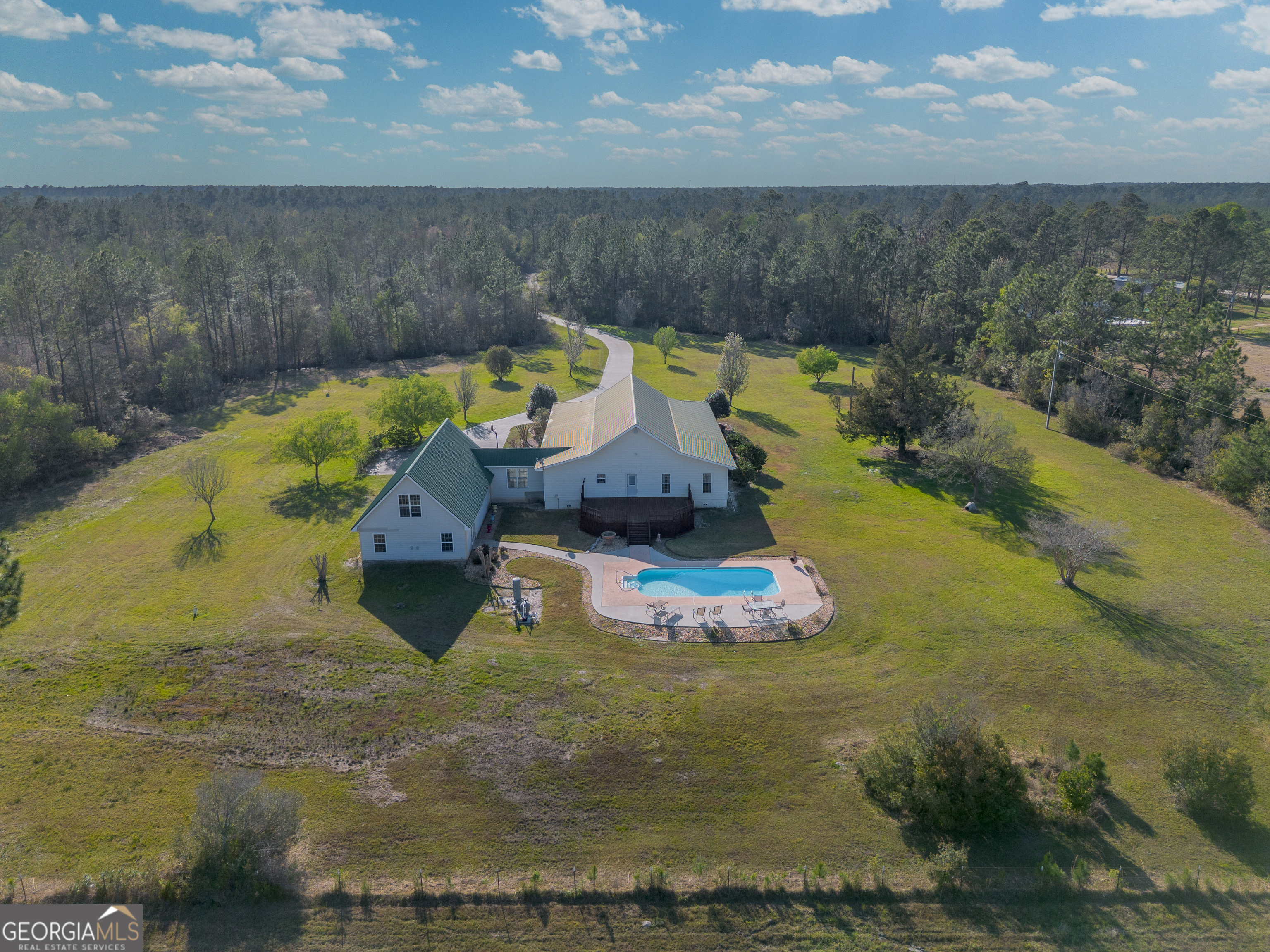 3300 Connor Lane Waycross, GA 31503 - Photo 7 of 42 a view of a swimming pool with lawn chairs