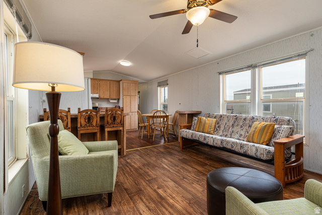740 Riddle Drive Fredonia, AZ 86022 - Photo 1 of 20 Open concept living area featuring wood-finish flooring, multiple window exposures, a ceiling fan with integrated lighting, and natural wood cabinetry