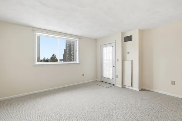 a view of a room with window and ceiling fan