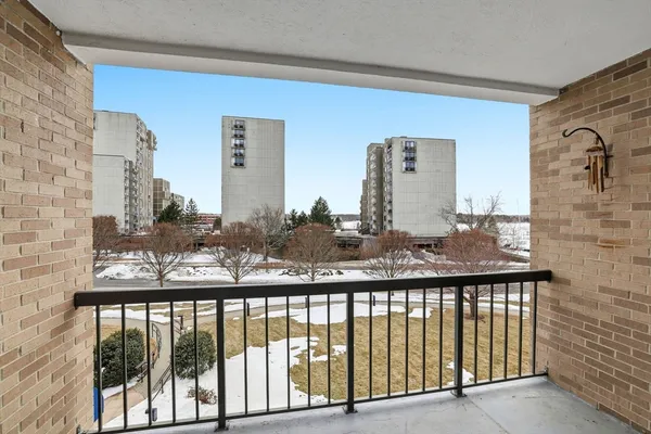 a view of a balcony with a barbeque