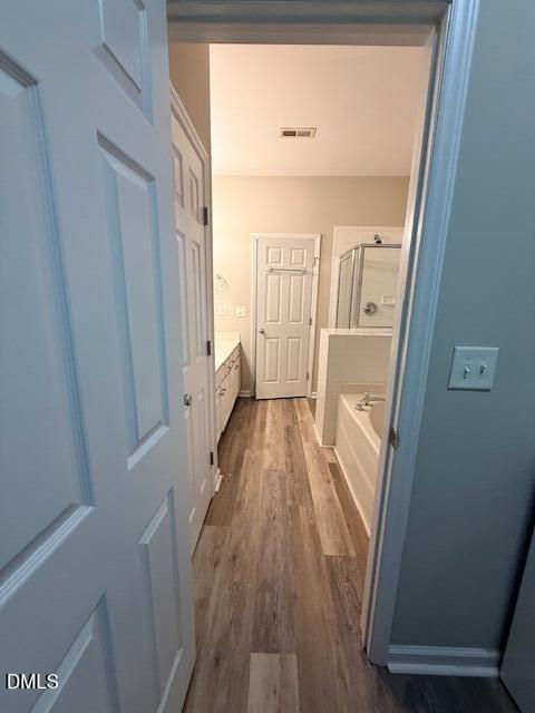 8427 Stone Mason Drive Raleigh, NC 27613 - Photo 16 of 28 a view of a hallway with wooden floor and staircase