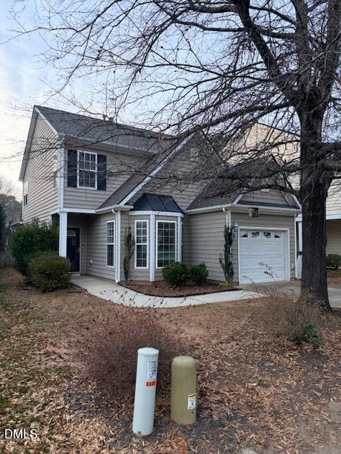 8427 Stone Mason Drive Raleigh, NC 27613 - Photo 2 of 28 a front view of a house with a yard and garage
