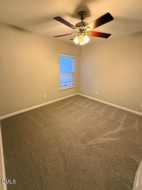 8427 Stone Mason Drive Raleigh, NC 27613 - Photo 23 of 28 an empty room with a chandelier fan and windows