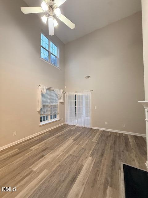 8427 Stone Mason Drive Raleigh, NC 27613 - Photo 7 of 28 an empty room with a ceiling fan and window