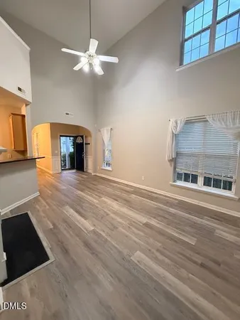 a view of empty room with a fireplace and wooden floor