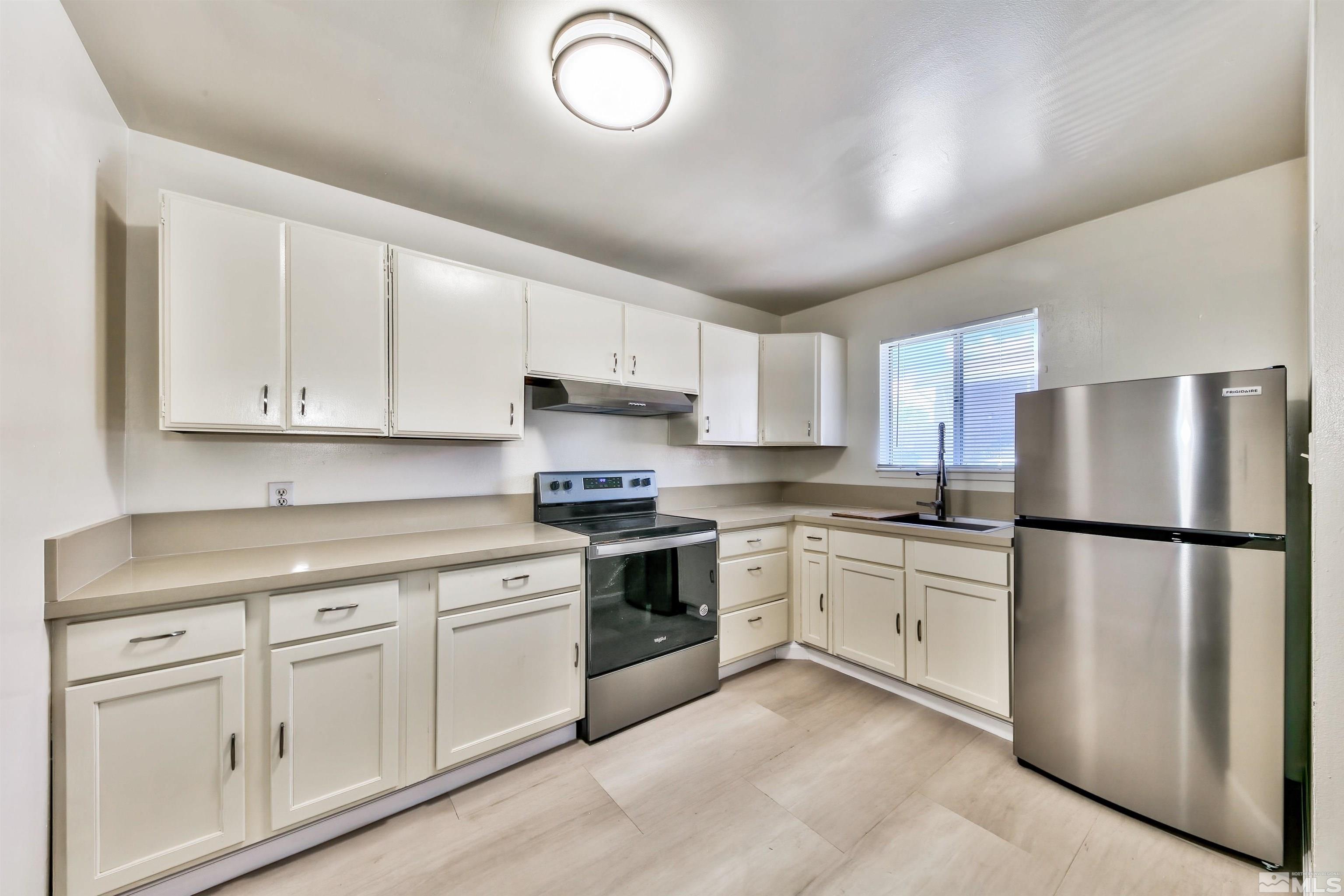 420 Lee Street Carson City, NV 89706 - Photo 15 of 29 a kitchen with white cabinets and white appliances
