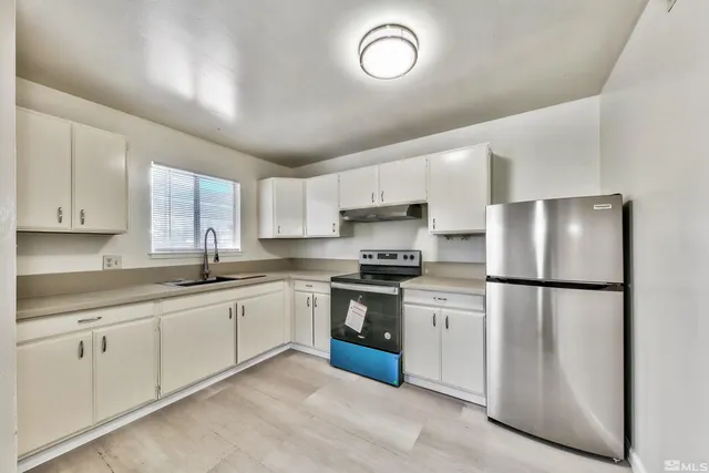 a kitchen with white cabinets and white appliances