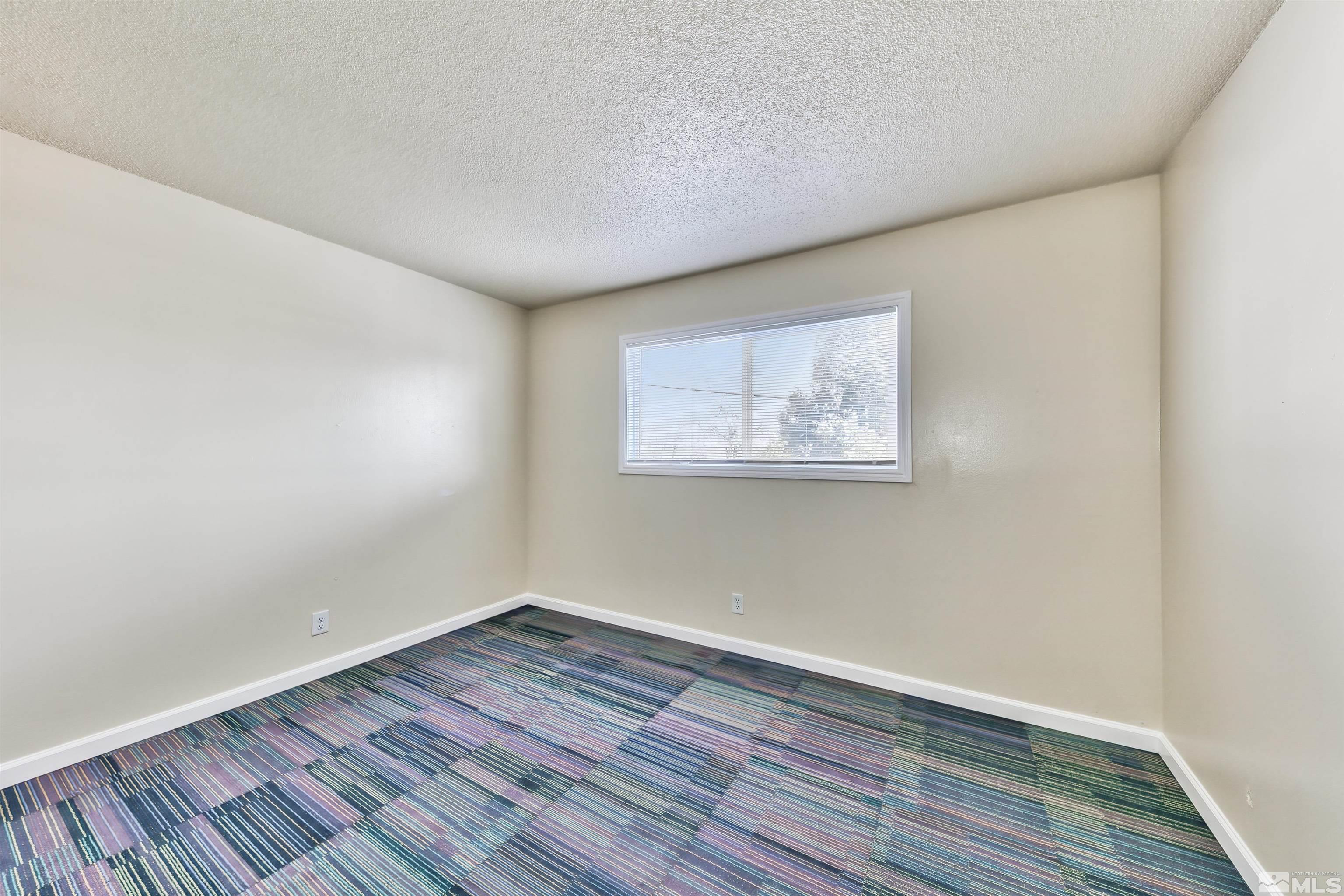 420 Lee Street Carson City, NV 89706 - Photo 25 of 29 an empty room with wooden floor and windows