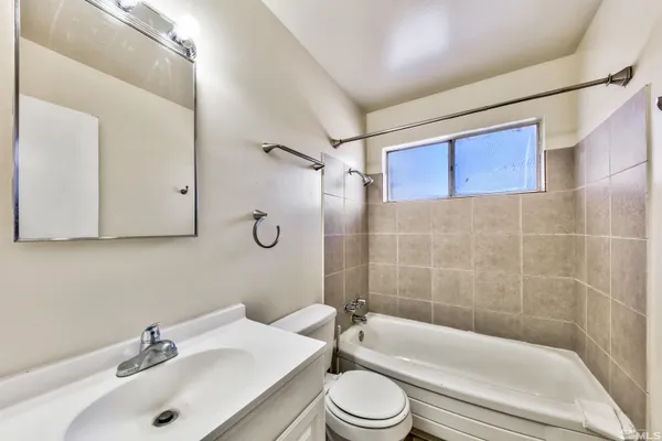 a bathroom with a sink a toilet and bathtub