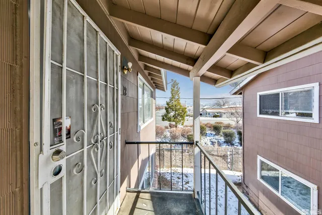 a view of a balcony with wooden floor
