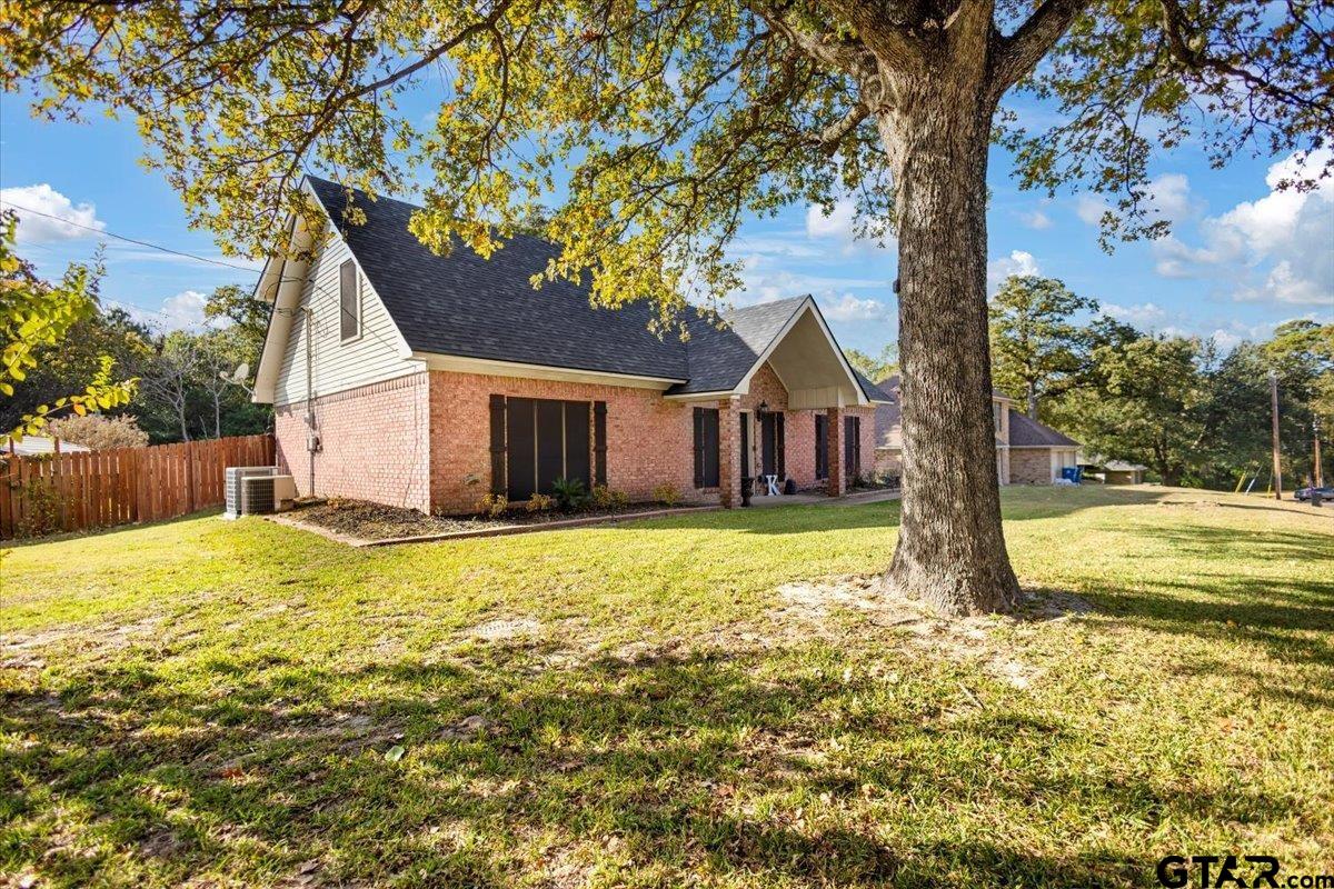 1701 Edgebrook Street Henderson, TX 75652 - Photo 1 of 36 a house with trees in front of it
