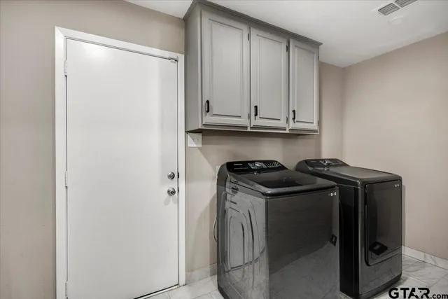 a view of walk in closet with clothes