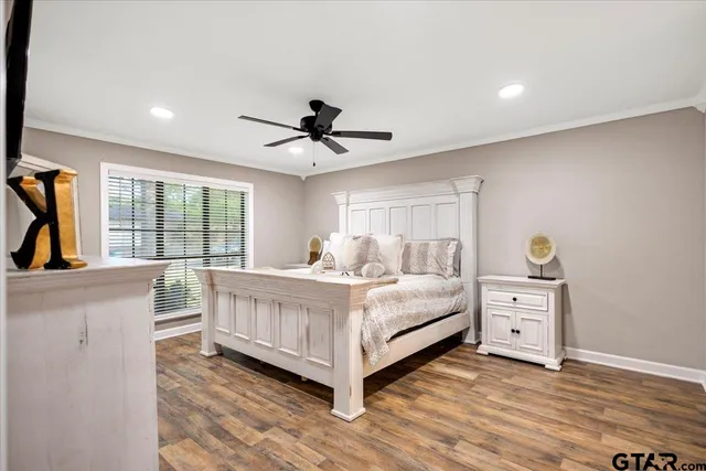 a view of a bedroom with furniture and windows
