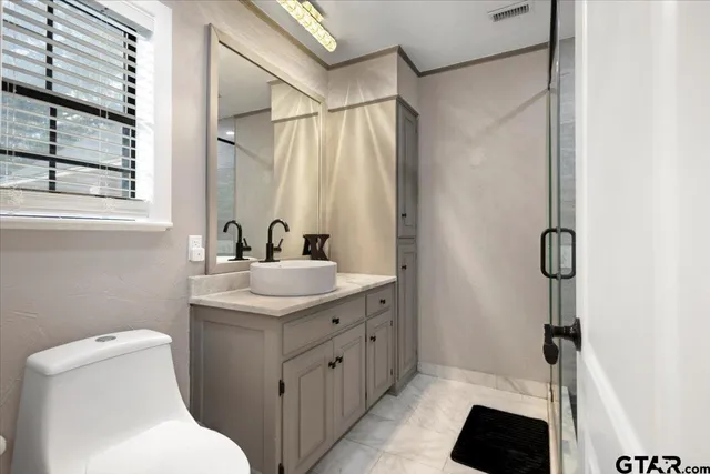 a bathroom with a sink toilet and shower