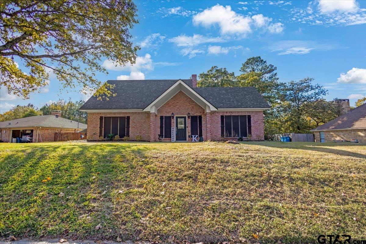 1701 Edgebrook Street Henderson, TX 75652 - Photo 2 of 36 a front view of a house with a garden