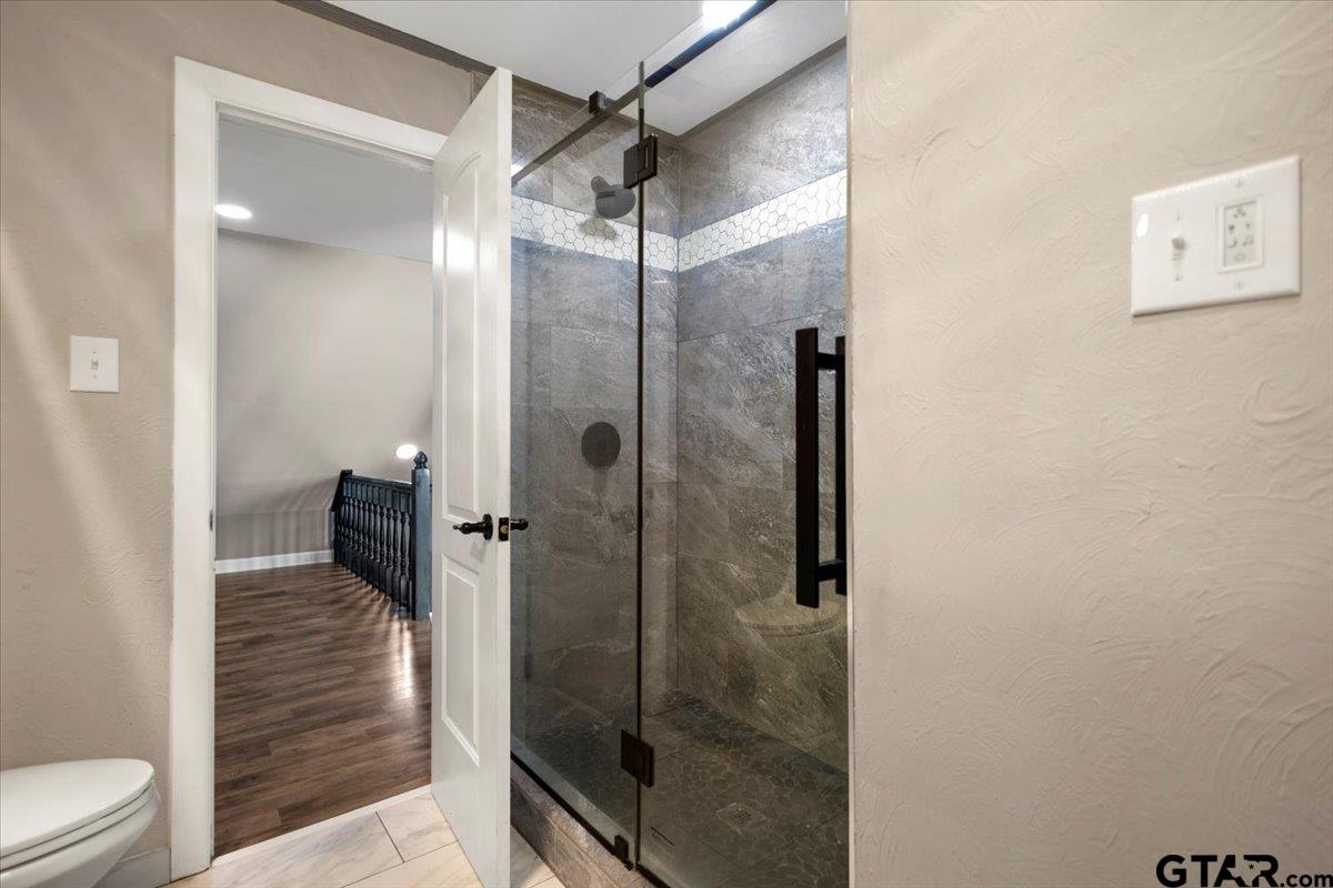 1701 Edgebrook Street Henderson, TX 75652 - Photo 23 of 36 a bathroom with a glass shower door