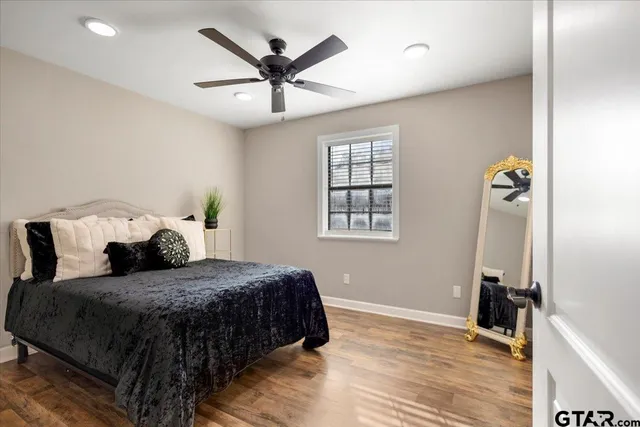 a bedroom with a large bed and a chandelier