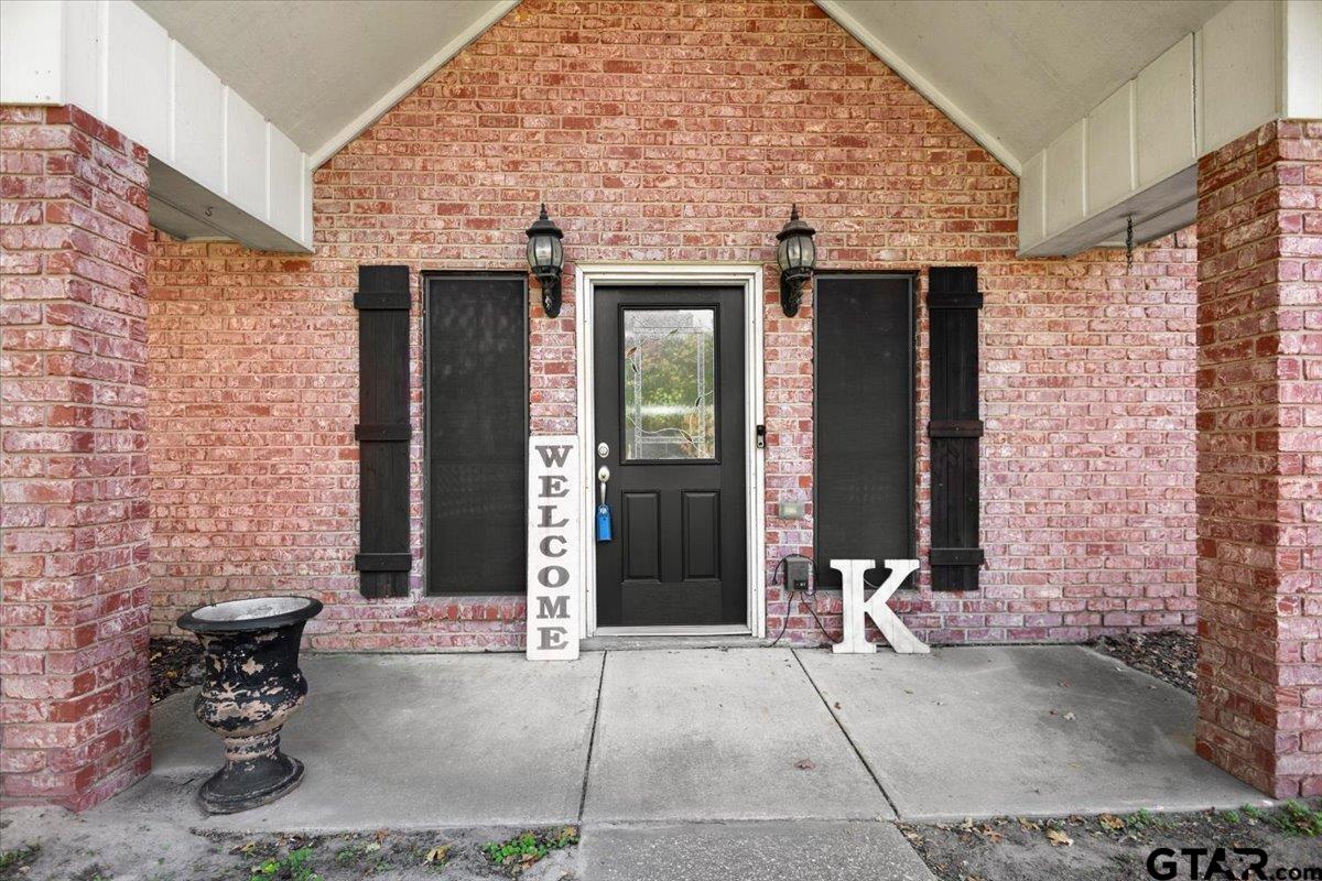 1701 Edgebrook Street Henderson, TX 75652 - Photo 5 of 36 a front view of a house with a bench