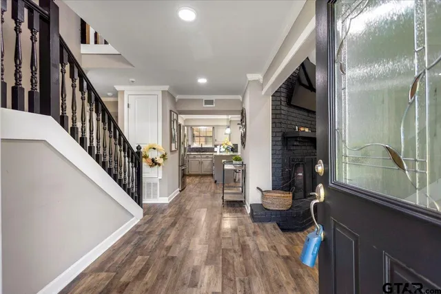 a dining room with wooden floor and a floor to ceiling window