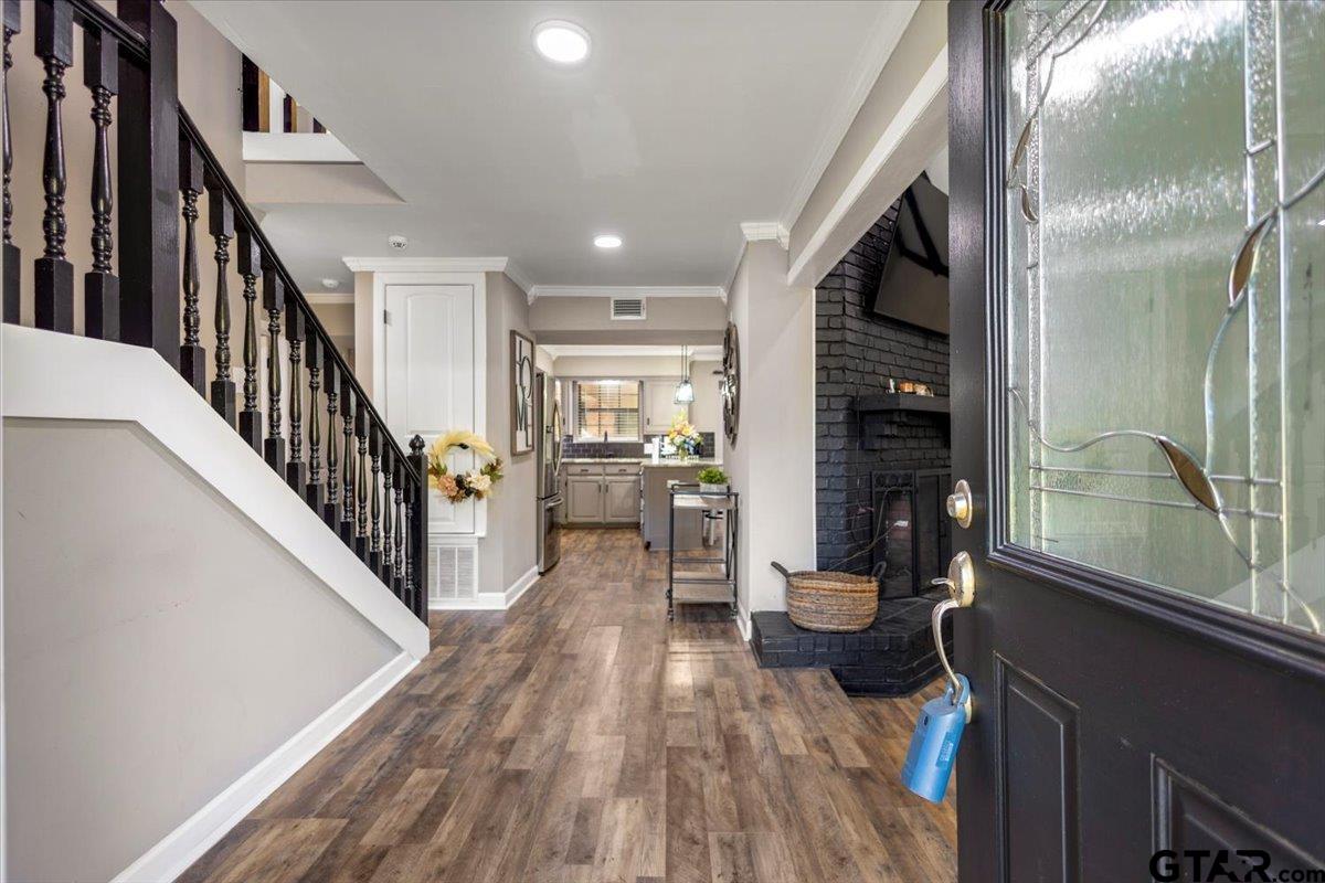 1701 Edgebrook Street Henderson, TX 75652 - Photo 6 of 36 a dining room with wooden floor and a floor to ceiling window