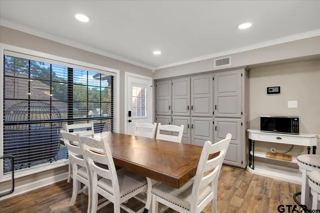 a dining room with furniture and wooden floor