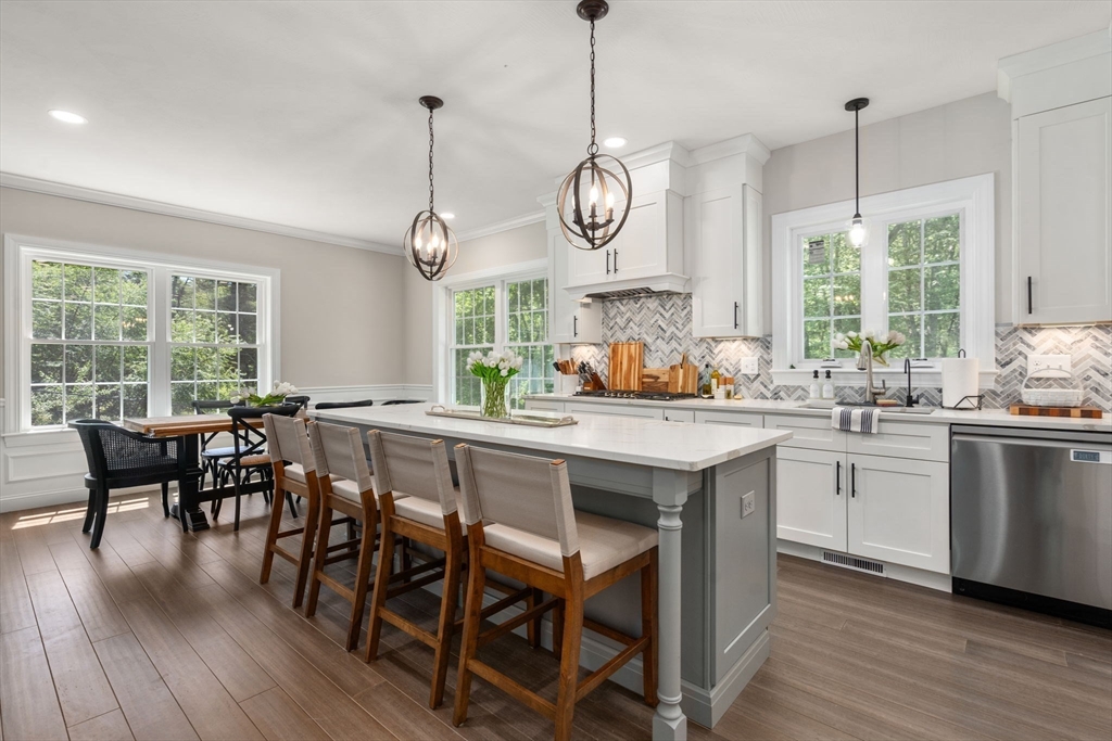 275 Chestnut Street Hudson, MA 01749 - Photo 1 of 34 a kitchen with stainless steel appliances granite countertop wooden floor cabinets and a window