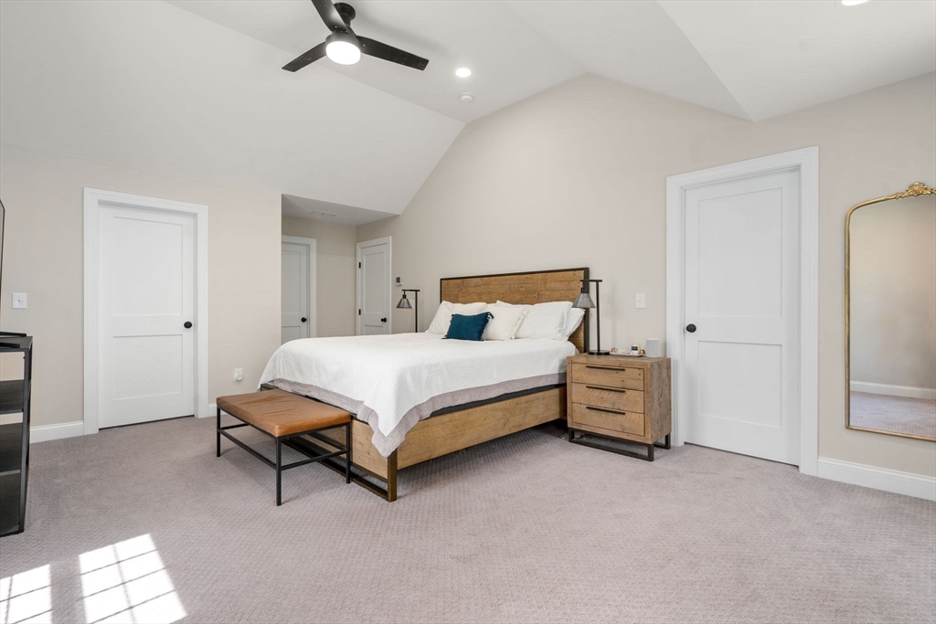 275 Chestnut Street Hudson, MA 01749 - Photo 15 of 34 a bedroom with a bed and a chandelier