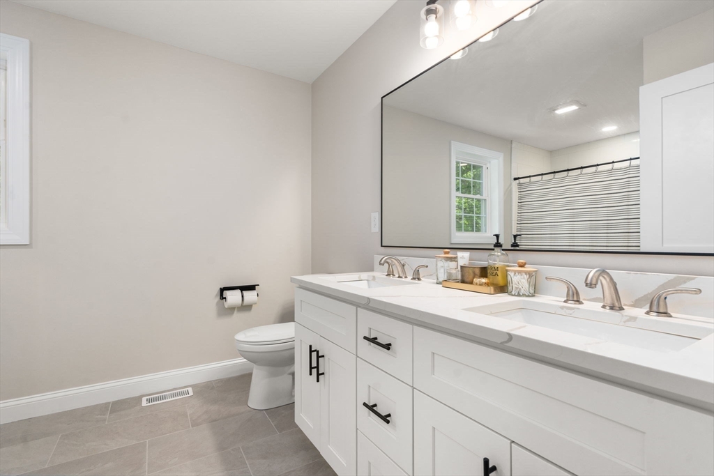 275 Chestnut Street Hudson, MA 01749 - Photo 16 of 34 a bathroom with a toilet sink and mirror