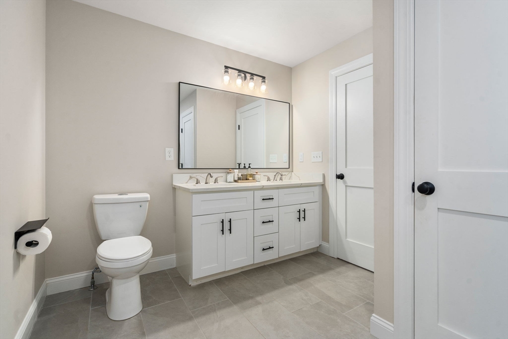 275 Chestnut Street Hudson, MA 01749 - Photo 17 of 34 a bathroom with a toilet sink and mirror