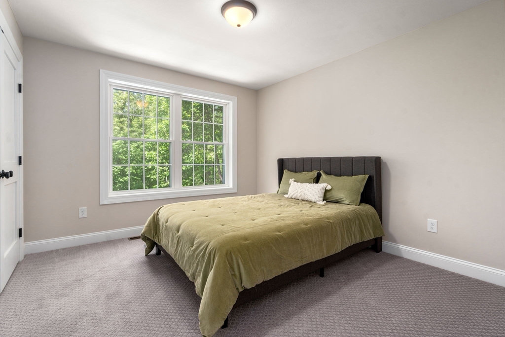 275 Chestnut Street Hudson, MA 01749 - Photo 19 of 34 a large bed sitting in a bedroom next to a window
