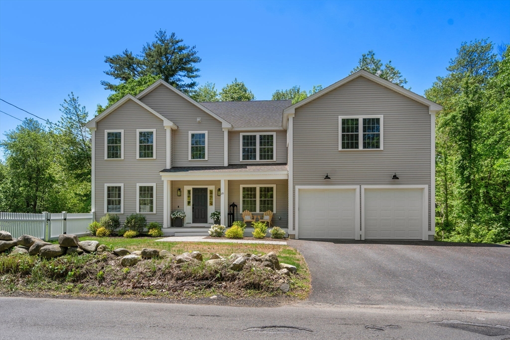 275 Chestnut Street Hudson, MA 01749 - Photo 25 of 34 a front view of a house with a yard