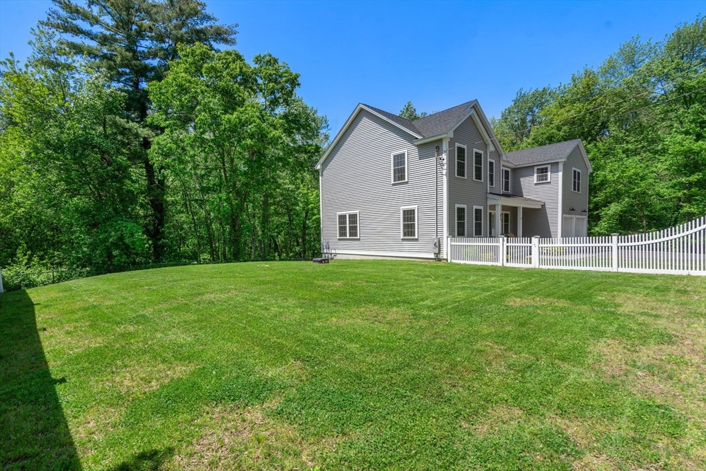 275 Chestnut Street Hudson, MA 01749 - Photo 31 of 34 a view of a house with a yard and sitting area
