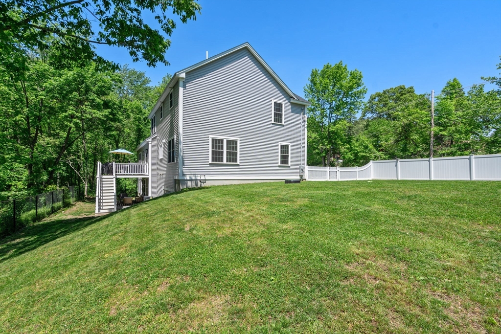 275 Chestnut Street Hudson, MA 01749 - Photo 32 of 34 a front view of a house with a yard
