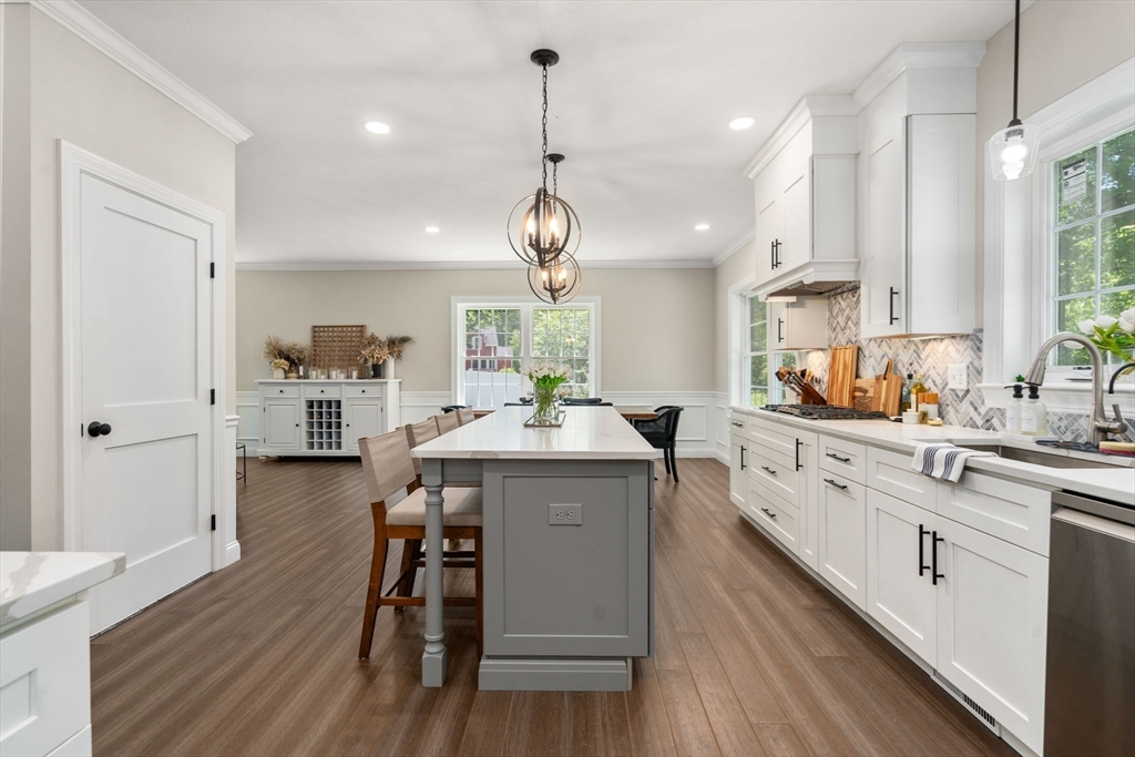 275 Chestnut Street Hudson, MA 01749 - Photo 4 of 34 a kitchen with wooden floors and white cabinets
