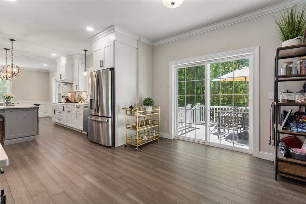 275 Chestnut Street Hudson, MA 01749 - Photo 8 of 34 a kitchen with stainless steel appliances a refrigerator and wooden floor