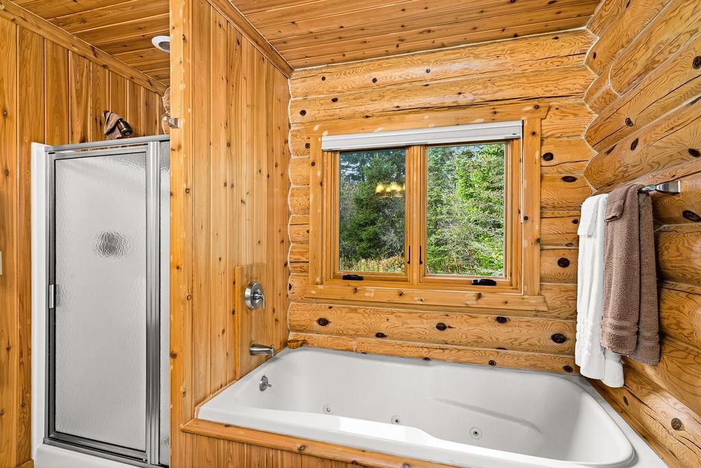 90190 Bark Point Road Herbster, WI 54844 - Photo 21 of 42 Full bathroom featuring a stall shower, a tub with jets, and wood ceiling