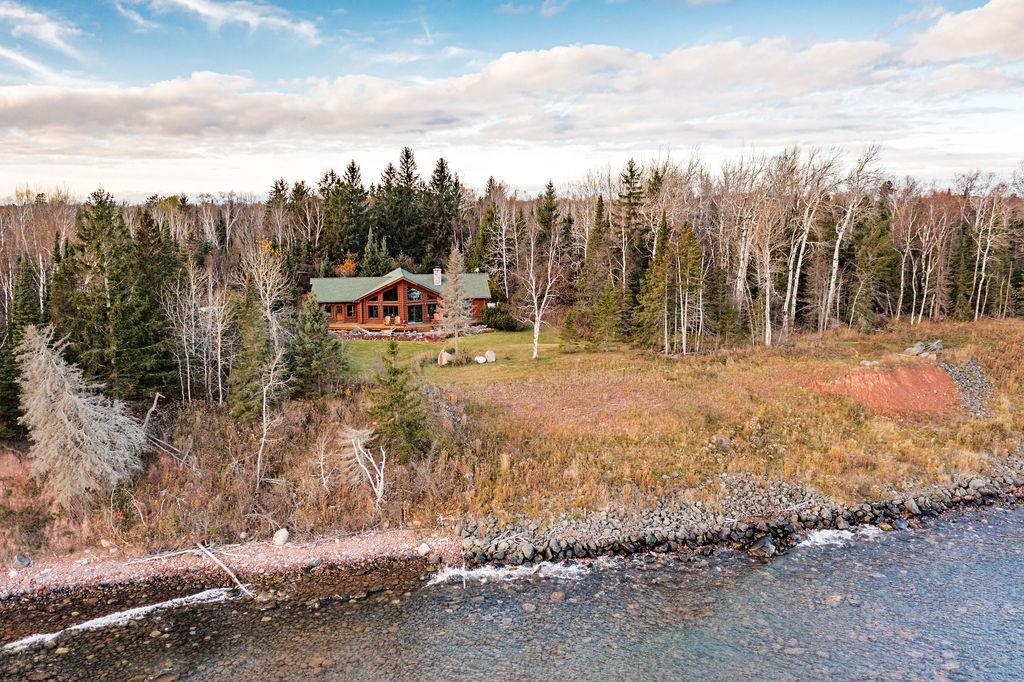 90190 Bark Point Road Herbster, WI 54844 - Photo 24 of 42 Aerial view of property and surrounding area with a large body of water and a heavily wooded area