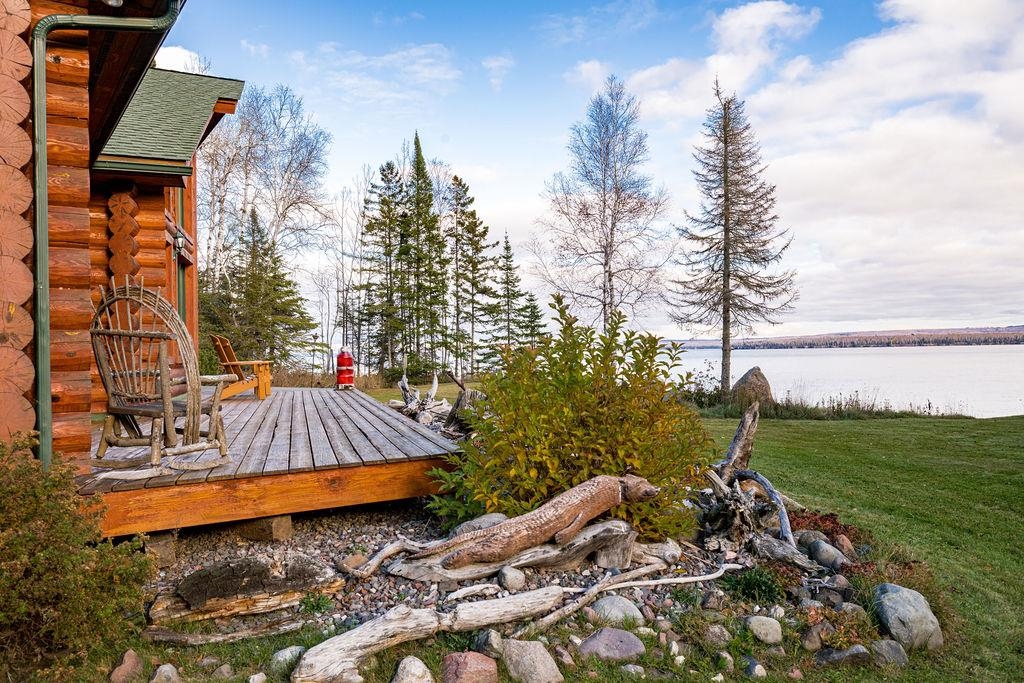 90190 Bark Point Road Herbster, WI 54844 - Photo 27 of 42 View of grassy yard with a deck with water view