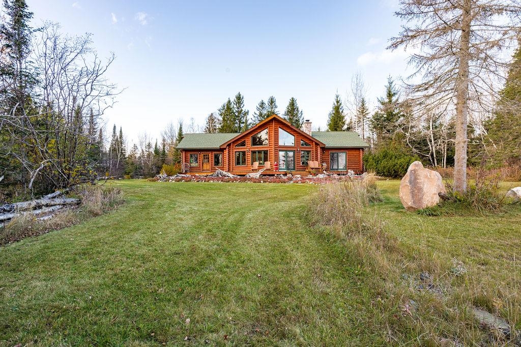 90190 Bark Point Road Herbster, WI 54844 - Photo 31 of 42 Rear view of property with a chimney and a yard
