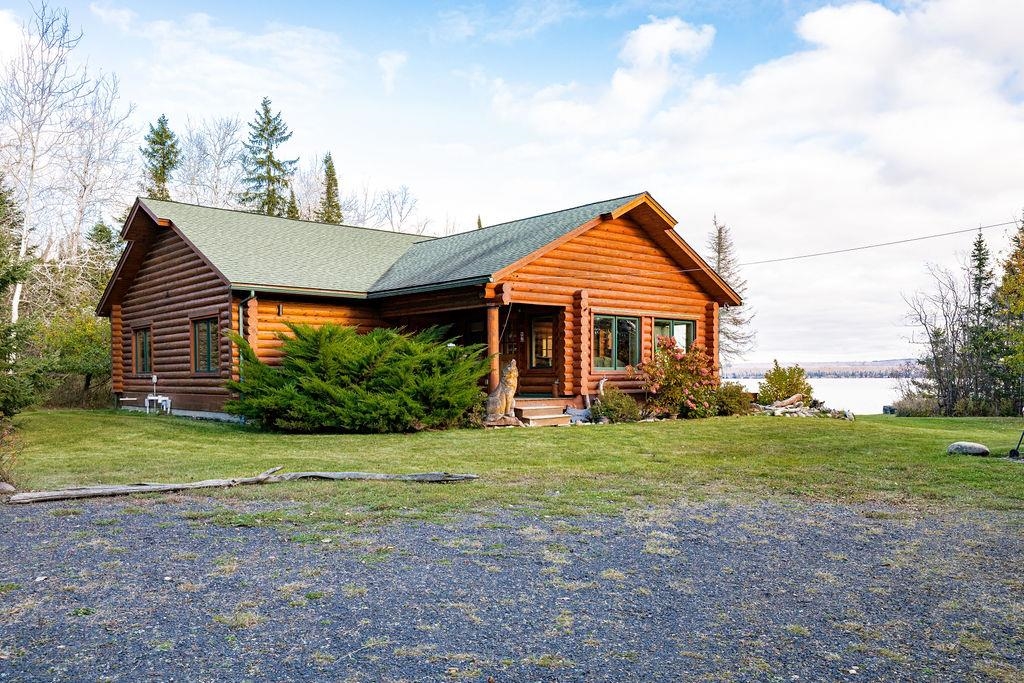 90190 Bark Point Road Herbster, WI 54844 - Photo 35 of 42 Log cabin featuring log siding, a front yard, a porch, and roof with shingles