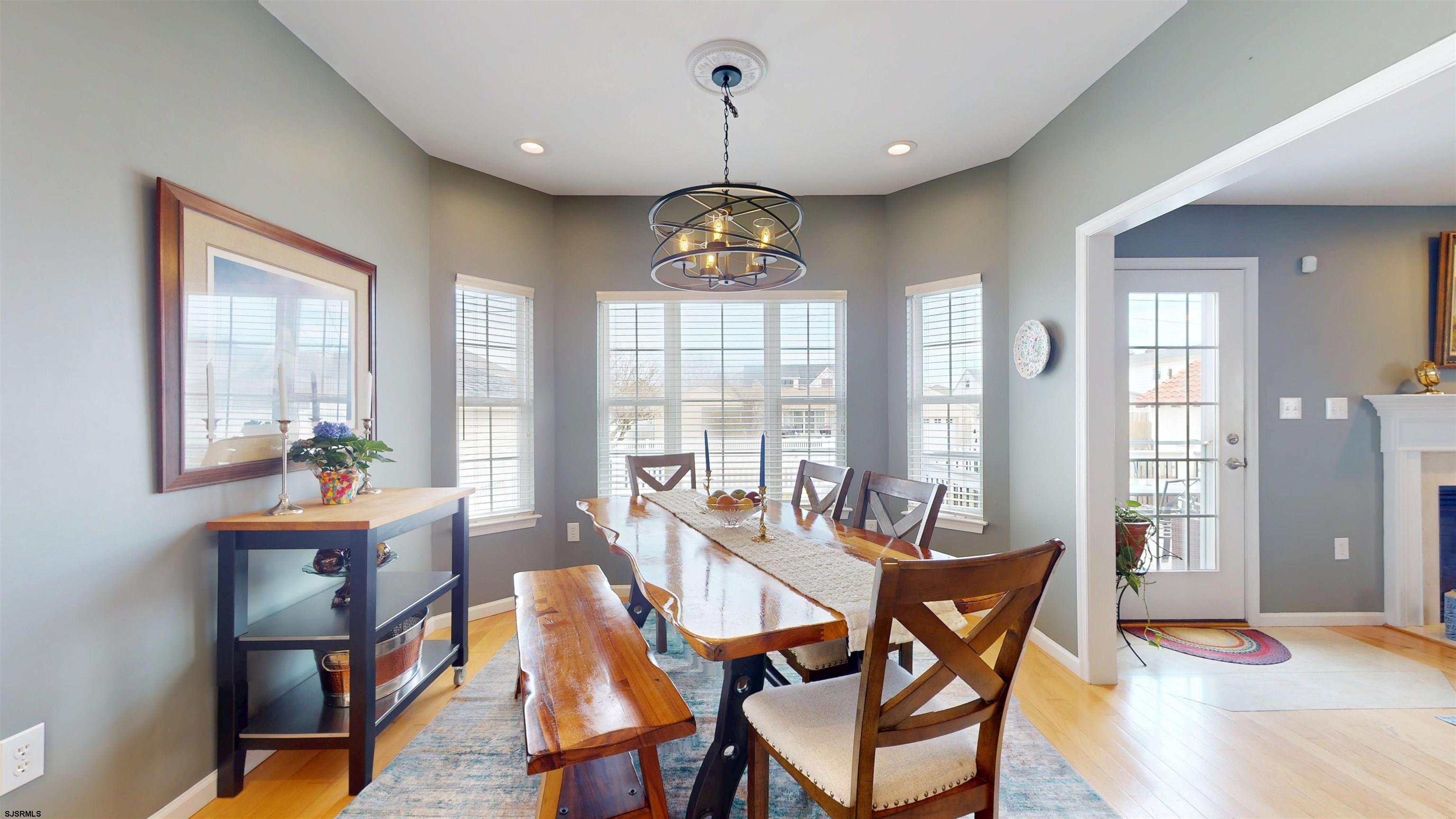201 25th Street South Brigantine, NJ 08203 - Photo 12 of 60 a dining room with furniture a chandelier and wooden floor