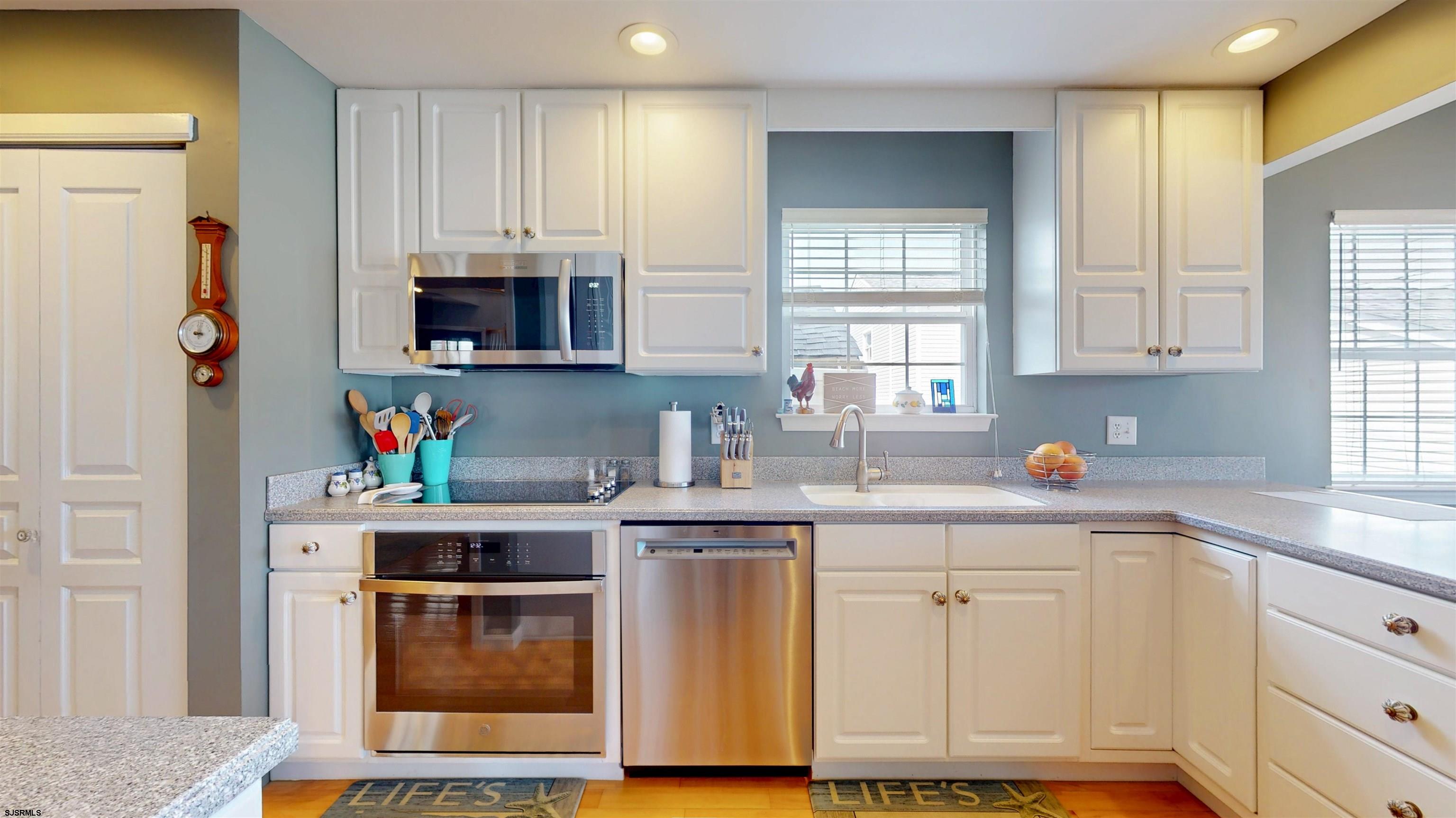 201 25th Street South Brigantine, NJ 08203 - Photo 15 of 60 a kitchen with stainless steel appliances granite countertop a stove a sink and a microwave