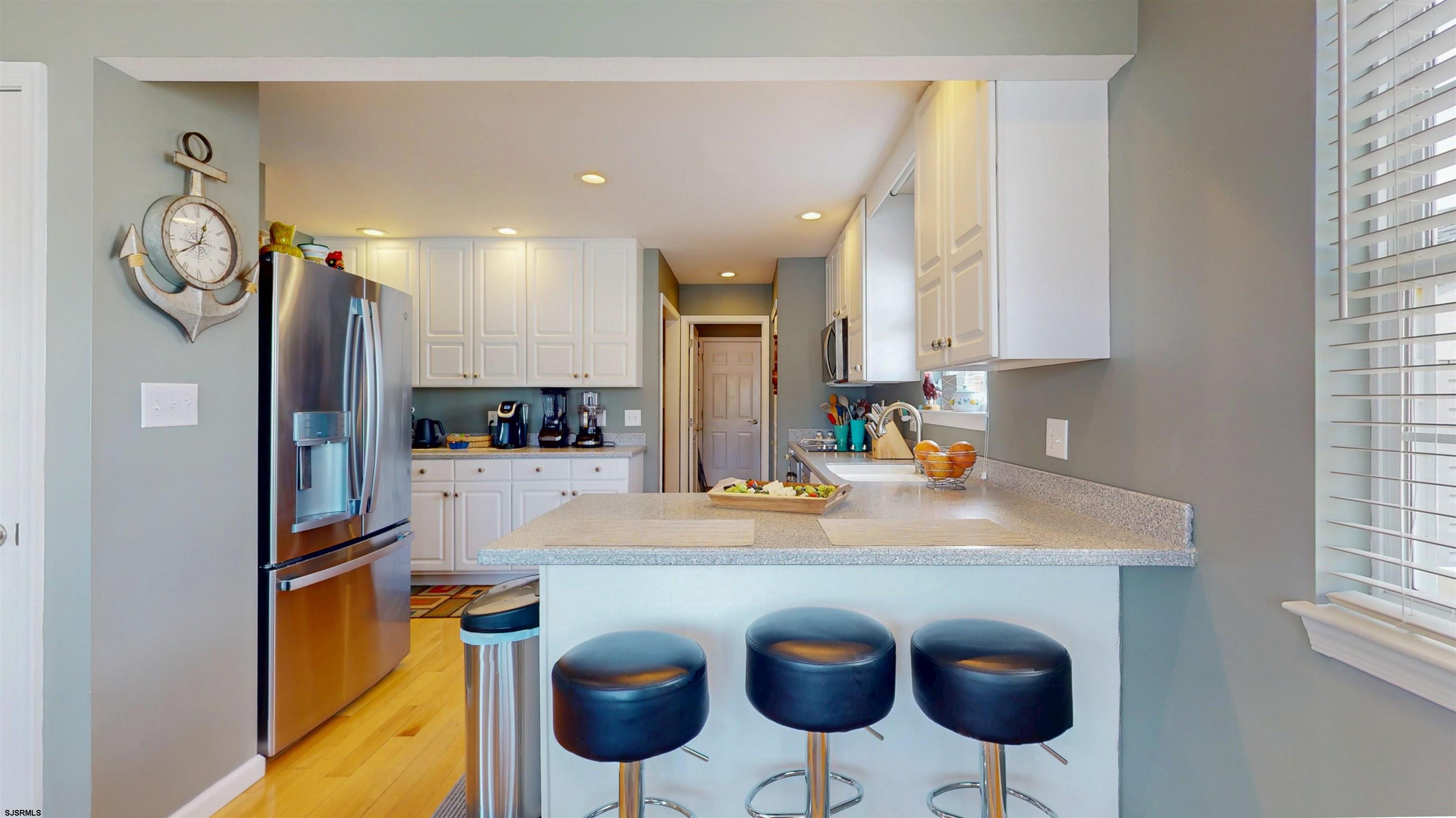 201 25th Street South Brigantine, NJ 08203 - Photo 20 of 60 a kitchen with stainless steel appliances granite countertop a sink and a refrigerator