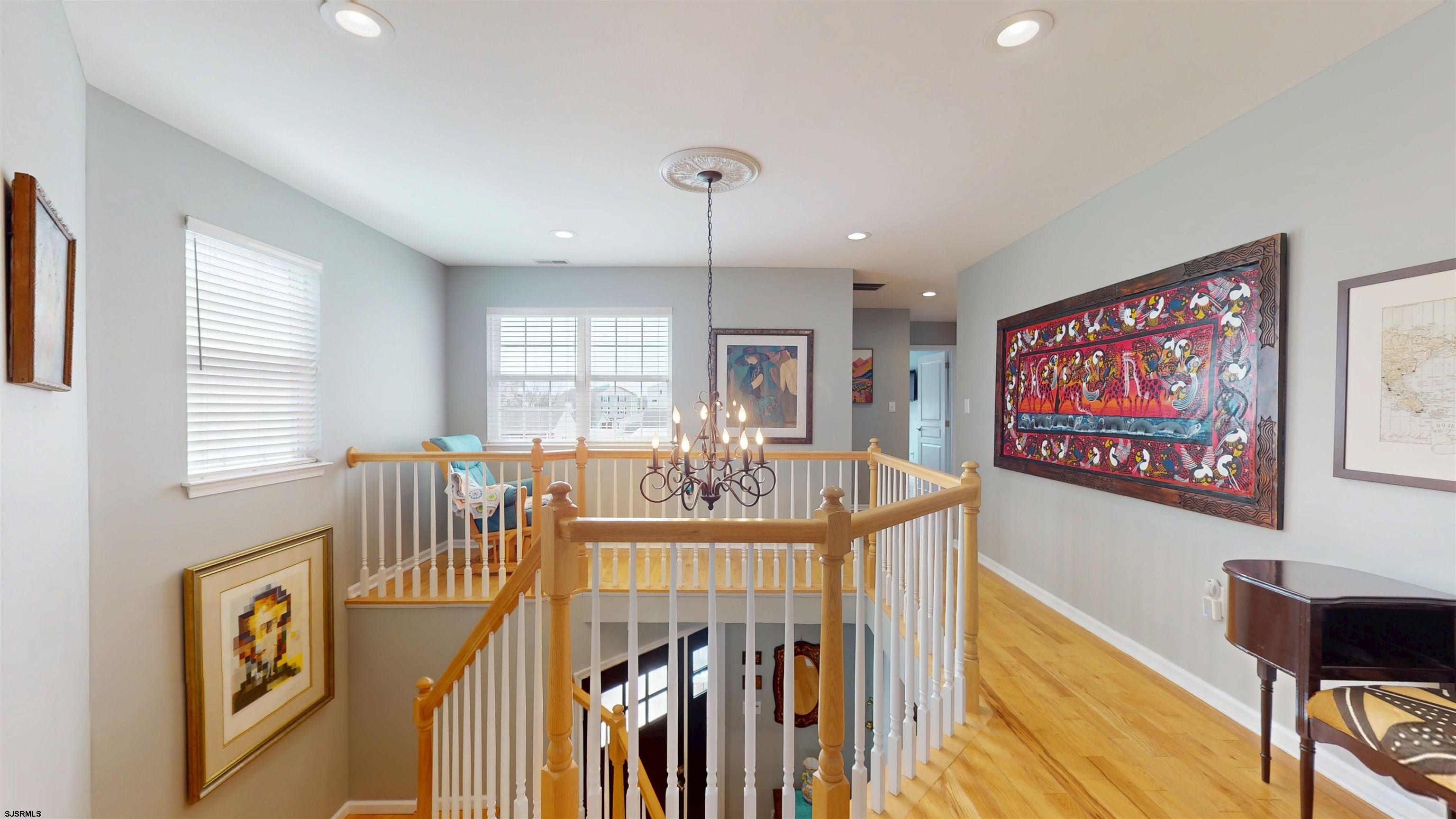201 25th Street South Brigantine, NJ 08203 - Photo 28 of 60 a view of a dining room with furniture a chandelier and wooden floor