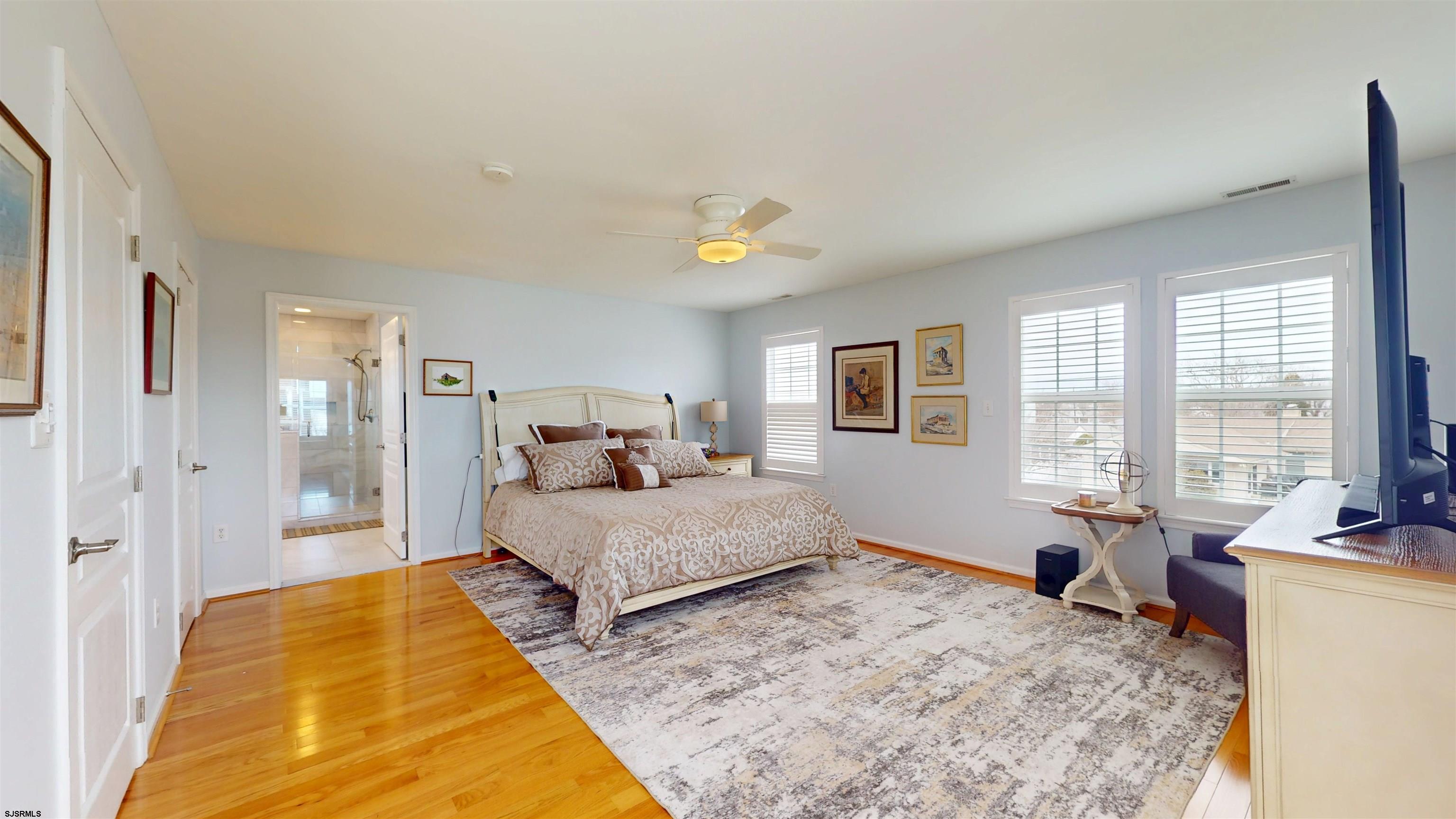 201 25th Street South Brigantine, NJ 08203 - Photo 30 of 60 a spacious bedroom with a bed and glass windows